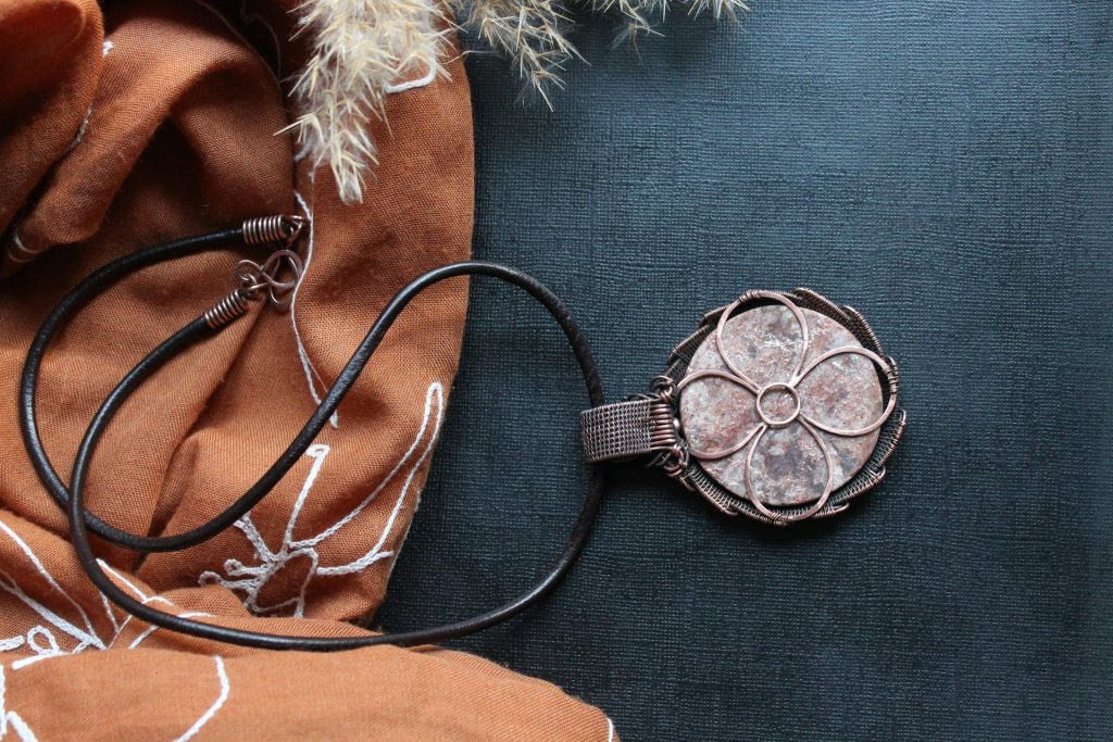 A scarf and a cell phone on a table