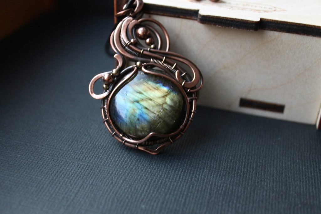 a picture of a necklace with a stone in it